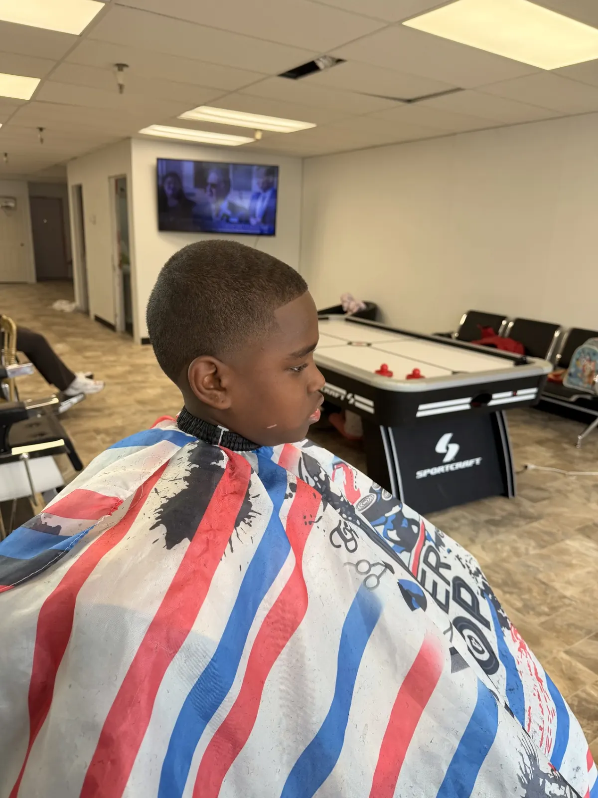 Young client with a fresh fade in the barber chair