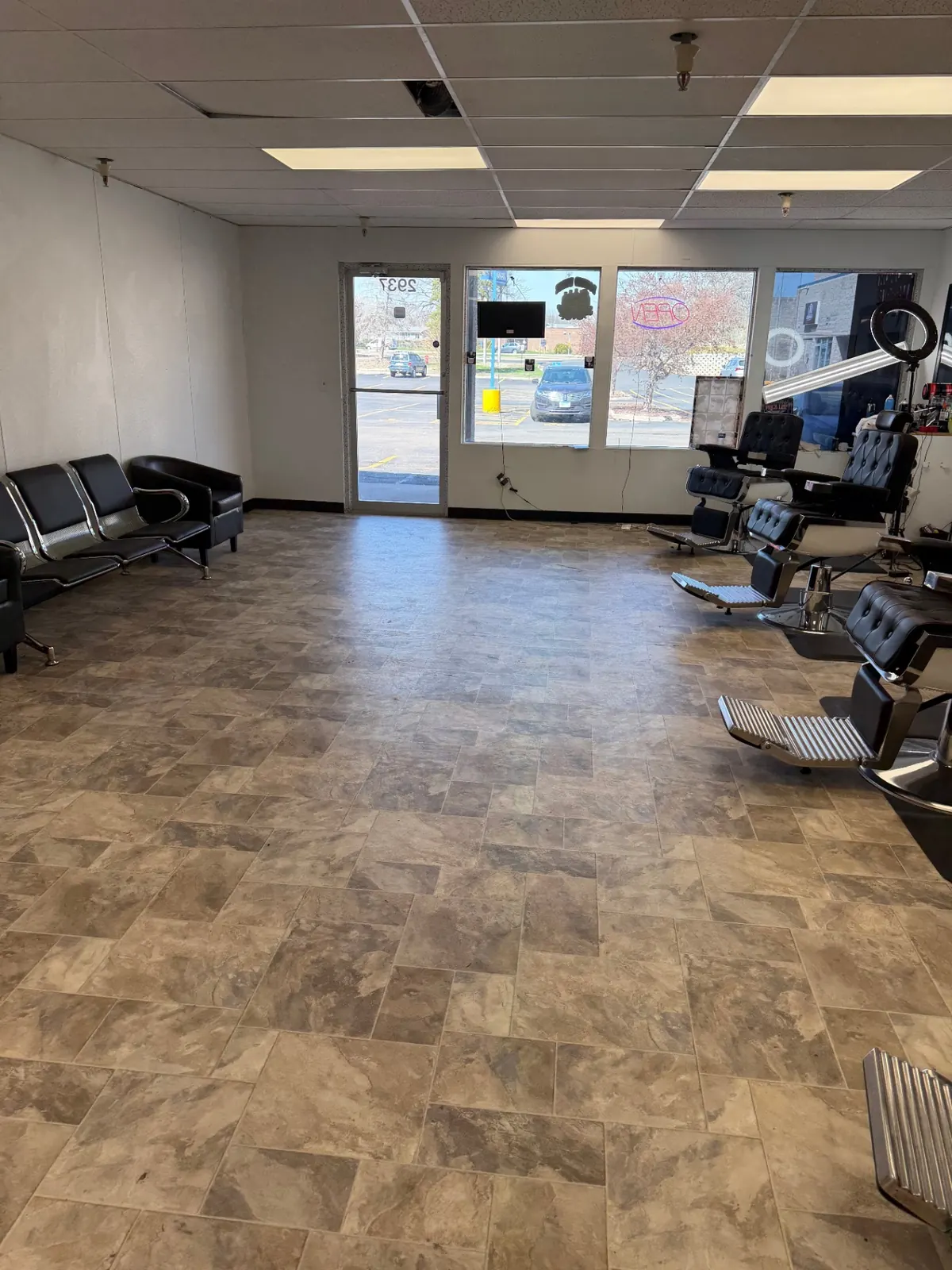 Inside Gentleman's Barbershop — waiting area and barber chairs
